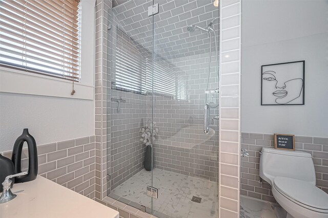 206 S Idaho St, La Porte, TX 77571 - full bath featuring tile walls, a stall shower, toilet, and wainscoting