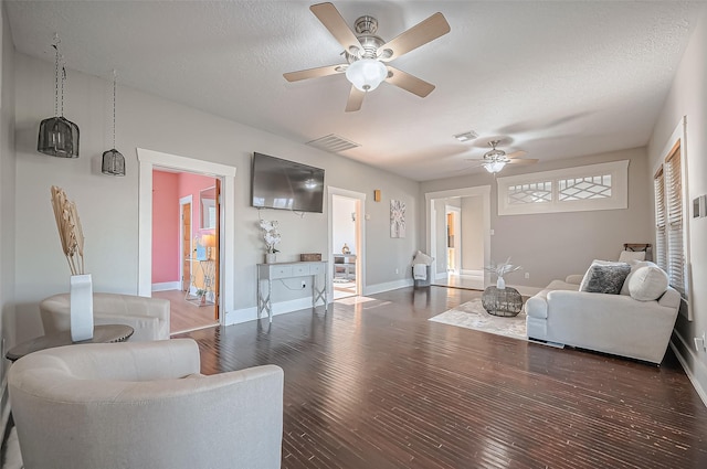 206 S Idaho St, La Porte, TX 77571 - living room with a ceiling fan, wood finished floors, baseboards, and a textured ceiling