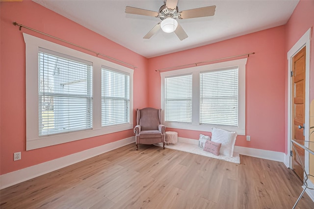 206 S Idaho St, La Porte, TX 77571 - sitting room with light wood-style floors, a ceiling fan, and baseboards