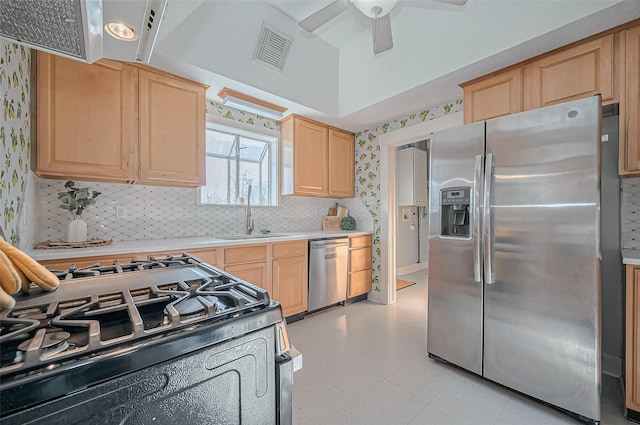 206 S Idaho St, La Porte, TX 77571 - kitchen featuring stainless steel appliances, a sink, light brown cabinets, light countertops, and a ceiling fan