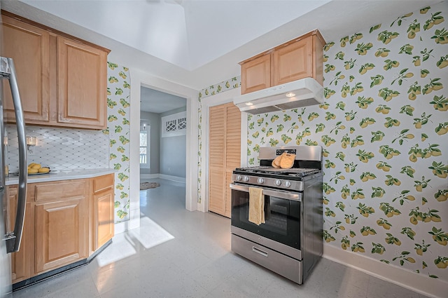 206 S Idaho St, La Porte, TX 77571 - kitchen with stainless steel range with gas cooktop, under cabinet range hood, wallpapered walls, baseboards, and light countertops