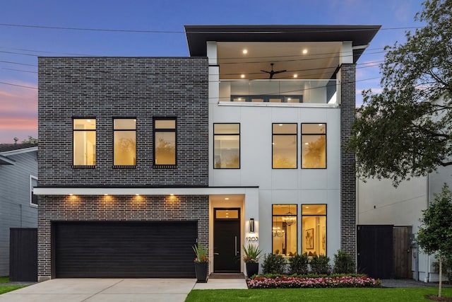 1203 Bomar St, Houston, TX 77006 - contemporary home with a garage, brick siding, and driveway
