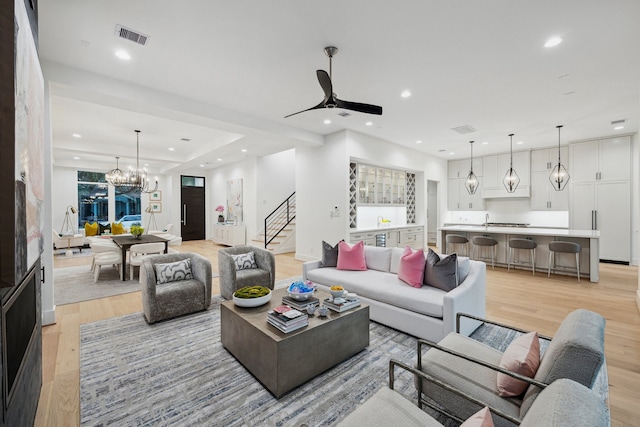 1203 Bomar St, Houston, TX 77006 - living room with light wood-style flooring, recessed lighting, stairway, a ceiling fan, and a chandelier