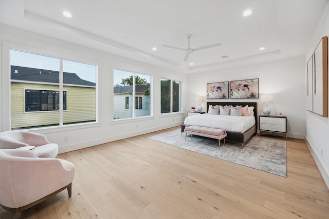 1203 Bomar St, Houston, TX 77006 - bedroom with a tray ceiling, light wood-style floors, baseboards, recessed lighting, and a ceiling fan