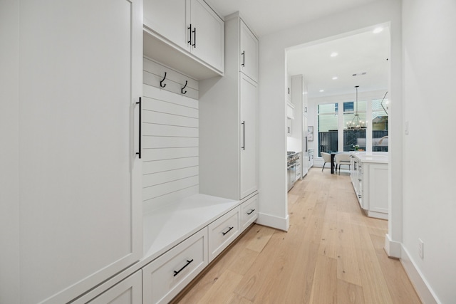 1203 Bomar St, Houston, TX 77006 - mudroom featuring light wood-type flooring, recessed lighting, a chandelier, and baseboards