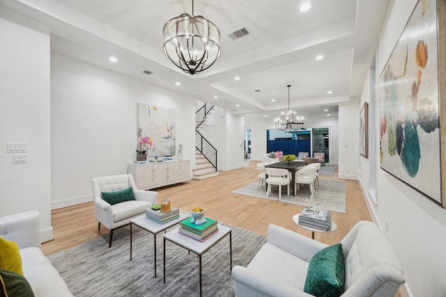 1203 Bomar St, Houston, TX 77006 - living area with a chandelier, a raised ceiling, stairway, light wood-style floors, and recessed lighting