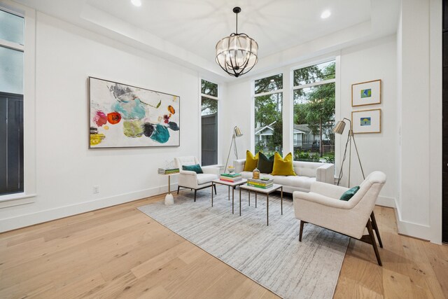 1203 Bomar St, Houston, TX 77006 - sitting room featuring a tray ceiling, light wood-style floors, a chandelier, recessed lighting, and baseboards