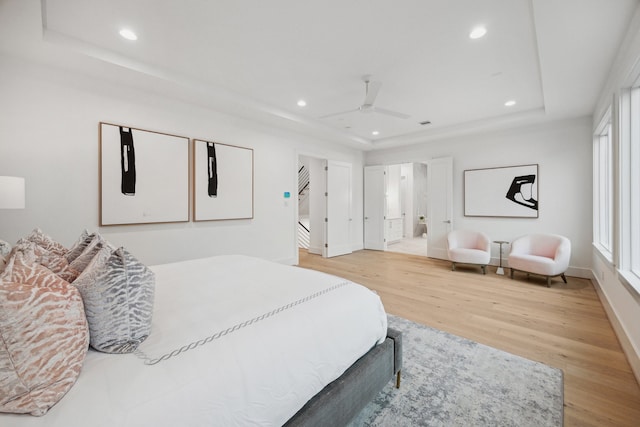 1203 Bomar St, Houston, TX 77006 - bedroom featuring a raised ceiling, light wood-style flooring, baseboards, recessed lighting, and a ceiling fan