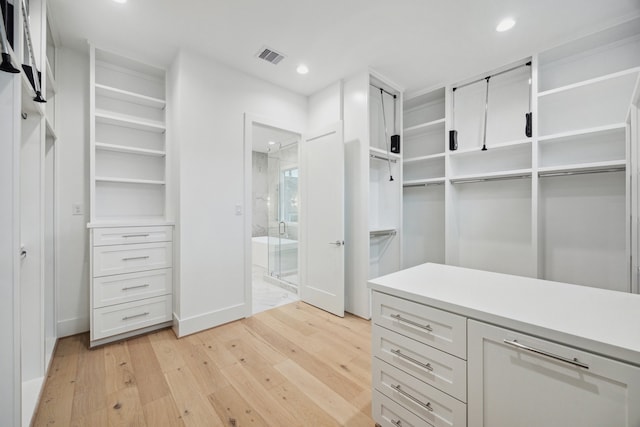 1203 Bomar St, Houston, TX 77006 - walk in closet featuring light wood-type flooring