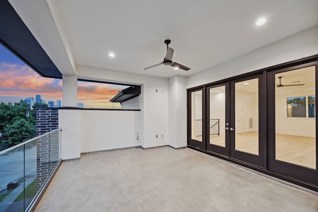 1203 Bomar St, Houston, TX 77006 - balcony at dusk featuring french doors and a ceiling fan