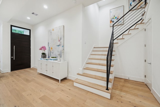 1203 Bomar St, Houston, TX 77006 - foyer with stairway, light wood-type flooring, baseboards, and recessed lighting