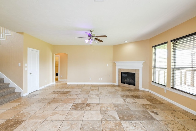 2123 Witham Park Ln, Fresno, TX 77545 - unfurnished living room featuring ceiling fan, a fireplace, stairway, and baseboards