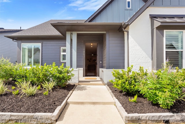 18631 Joyous Ln, Cypress, TX 77433 - property entrance with board and batten siding, roof with shingles, and brick siding