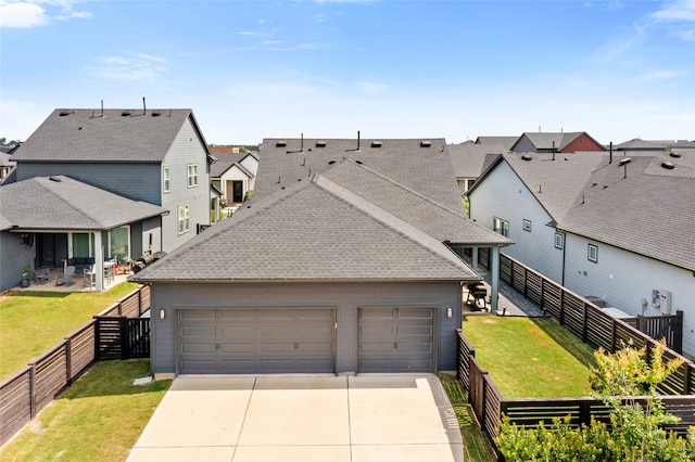18631 Joyous Ln, Cypress, TX 77433 - view of front of home with a residential view, driveway, an attached garage, and a shingled roof