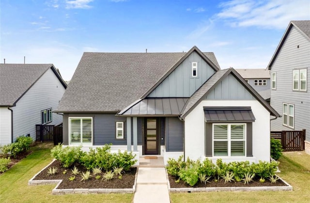 18631 Joyous Ln, Cypress, TX 77433 - view of front of house featuring board and batten siding, a standing seam roof, a shingled roof, and metal roof