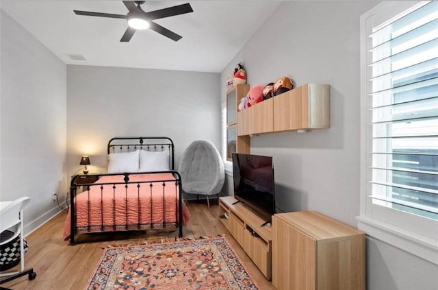 18631 Joyous Ln, Cypress, TX 77433 - bedroom with light wood-style flooring and a ceiling fan