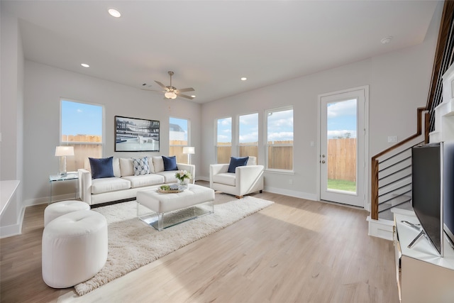 13216 Opera Dr, Houston, TX 77047 - living area with stairway, light wood finished floors, baseboards, and recessed lighting