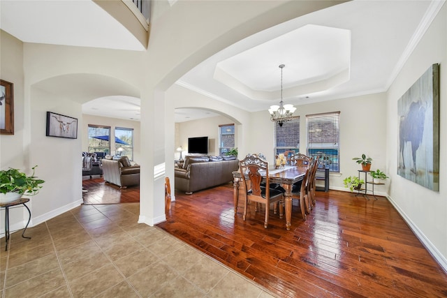 3610 Rock Daisy Dr, Spring, TX 77386 - dining space featuring arched walkways, a chandelier, baseboards, and a raised ceiling