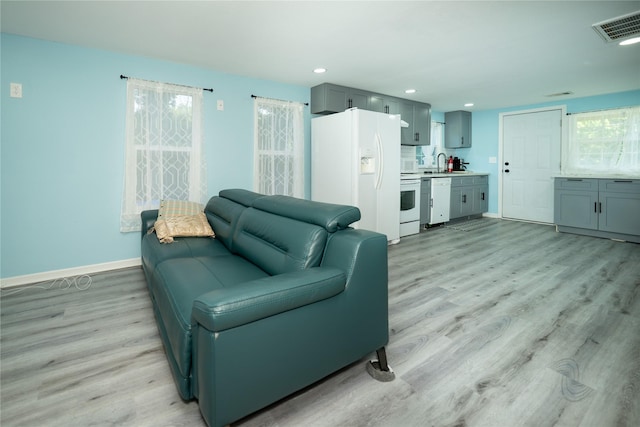 570 Fm 232, Crockett, TX 75835 - living area featuring light wood-style flooring, baseboards, healthy amount of natural light, and recessed lighting