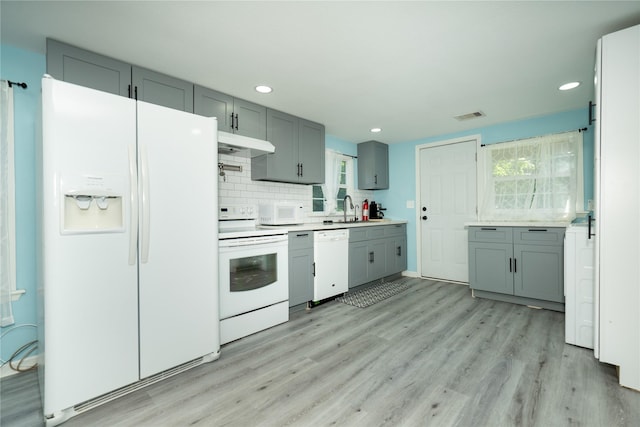 570 Fm 232, Crockett, TX 75835 - kitchen with white appliances, under cabinet range hood, light wood-style floors, light countertops, and recessed lighting