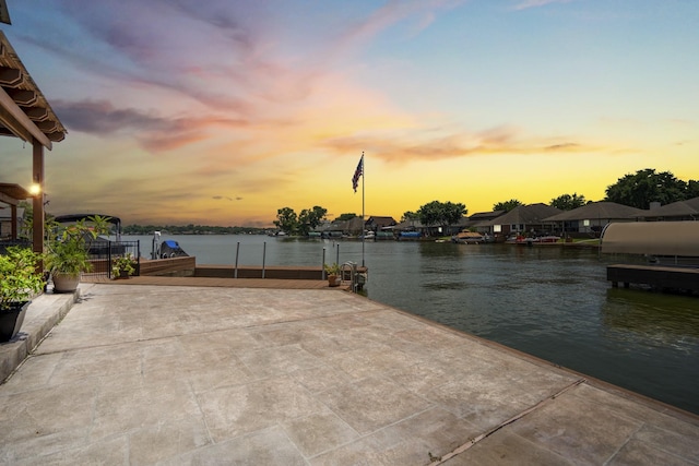 13685 Lakeside Place Dr, Willis, TX 77318 - patio terrace at dusk featuring a water view and a dock