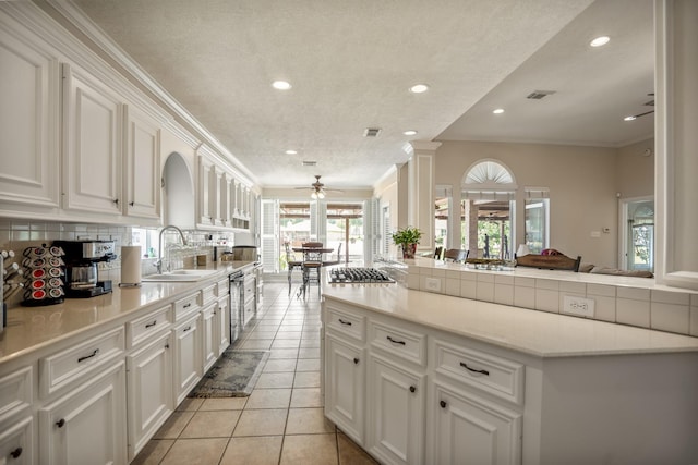 13685 Lakeside Place Dr, Willis, TX 77318 - kitchen with recessed lighting, ceiling fan, white cabinets, light tile patterned floors, and light countertops