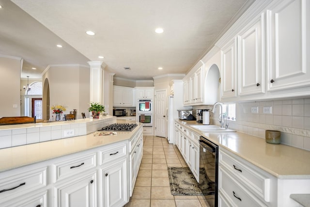 13685 Lakeside Place Dr, Willis, TX 77318 - kitchen with black dishwasher, recessed lighting, decorative backsplash, stainless steel gas cooktop, and light tile patterned flooring