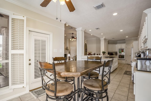 13685 Lakeside Place Dr, Willis, TX 77318 - dining room with a ceiling fan, light tile patterned floors, crown molding, recessed lighting, and decorative columns