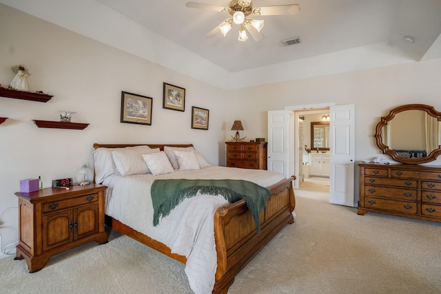 13685 Lakeside Place Dr, Willis, TX 77318 - bedroom featuring light carpet, ensuite bathroom, and a ceiling fan