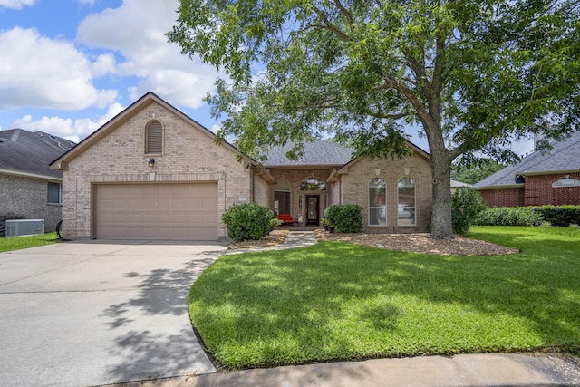13685 Lakeside Place Dr, Willis, TX 77318 - french provincial home with brick siding, concrete driveway, a garage, and a front yard