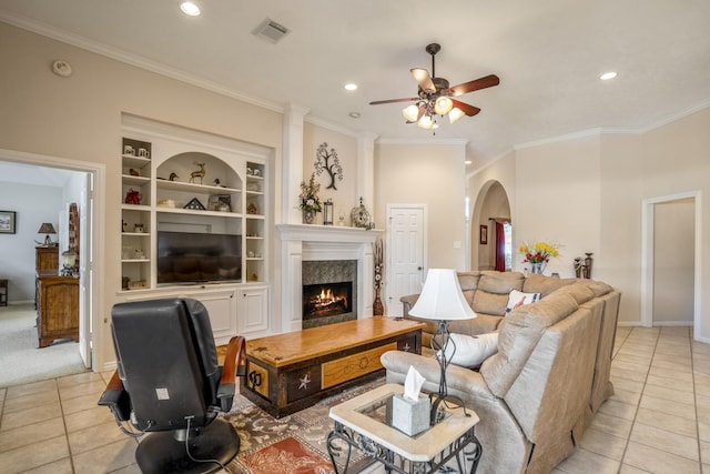 13685 Lakeside Place Dr, Willis, TX 77318 - living room featuring light tile patterned floors, crown molding, a ceiling fan, arched walkways, and recessed lighting
