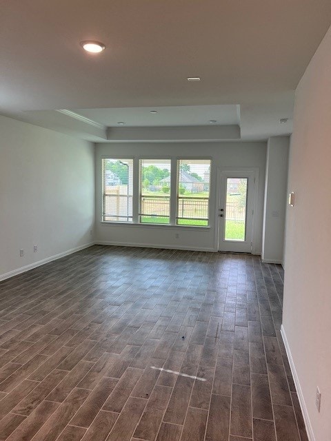 26715 Grandiflora Dr, Magnolia, TX 77355 - unfurnished room with a raised ceiling, healthy amount of natural light, dark wood-type flooring, baseboards, and recessed lighting