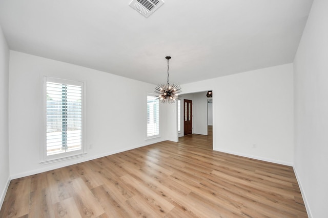 722 Merrick Dr, Sugar Land, TX 77478 - empty room featuring a chandelier, light wood-style flooring, and baseboards