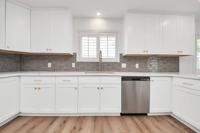 722 Merrick Dr, Sugar Land, TX 77478 - kitchen featuring stainless steel dishwasher, a sink, healthy amount of natural light, light countertops, and recessed lighting
