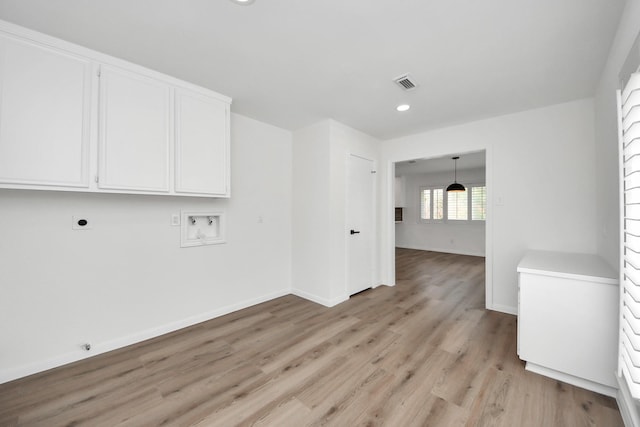 722 Merrick Dr, Sugar Land, TX 77478 - laundry room with hookup for an electric dryer, cabinet space, washer hookup, light wood-style flooring, and baseboards
