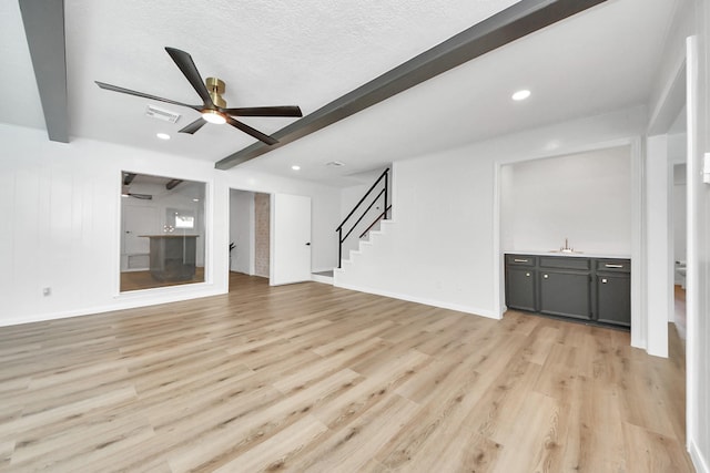 722 Merrick Dr, Sugar Land, TX 77478 - unfurnished living room with beam ceiling, a sink, a ceiling fan, light wood-type flooring, and stairs