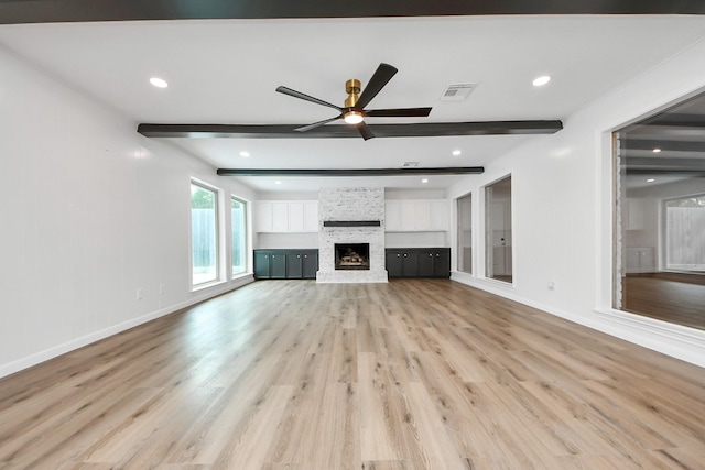 722 Merrick Dr, Sugar Land, TX 77478 - unfurnished living room with ceiling fan, light wood finished floors, beamed ceiling, baseboards, and a fireplace