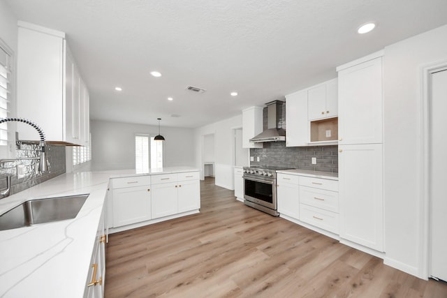 722 Merrick Dr, Sugar Land, TX 77478 - kitchen with electric stove, wall chimney exhaust hood, a sink, recessed lighting, and light stone countertops