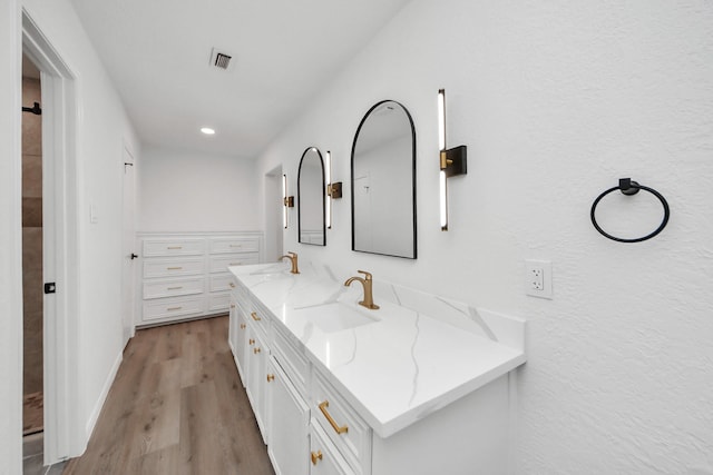 722 Merrick Dr, Sugar Land, TX 77478 - full bathroom featuring double vanity, wood finished floors, and recessed lighting