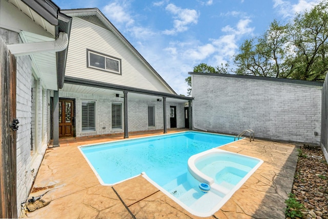 722 Merrick Dr, Sugar Land, TX 77478 - view of pool with a patio and a pool with connected hot tub