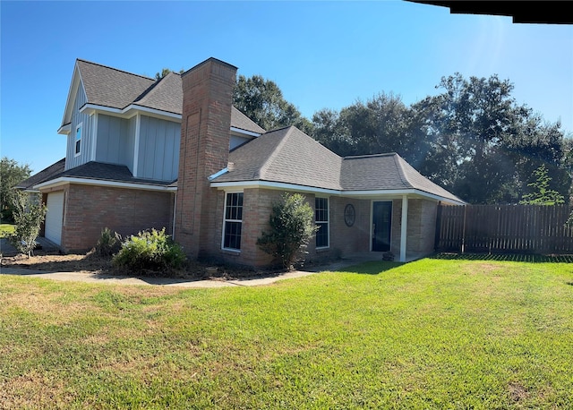12702 River Bend Dr, Mont Belvieu, TX 77523 - view of home's exterior featuring board and batten siding, a shingled roof, brick siding, a chimney, and a garage