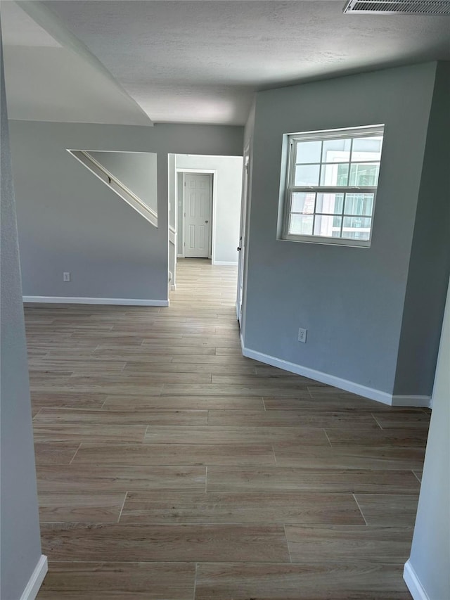 12702 River Bend Dr, Mont Belvieu, TX 77523 - spare room with baseboards and wood finished floors