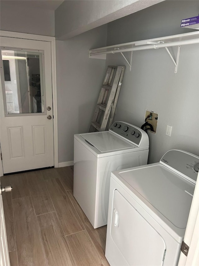 12702 River Bend Dr, Mont Belvieu, TX 77523 - laundry room featuring washer and clothes dryer and light wood-type flooring