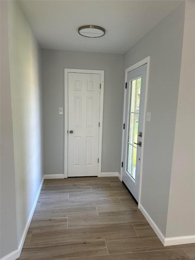 12702 River Bend Dr, Mont Belvieu, TX 77523 - doorway with light wood-style floors and baseboards