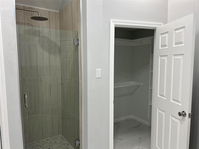 12702 River Bend Dr, Mont Belvieu, TX 77523 - bathroom featuring a stall shower, marble finish floors, and a walk in closet