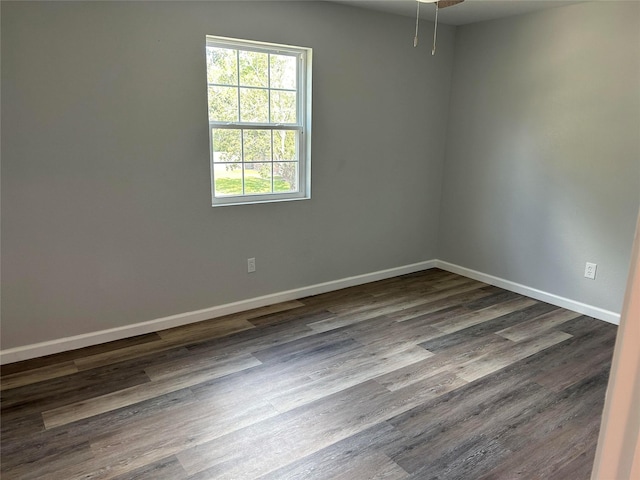 12702 River Bend Dr, Mont Belvieu, TX 77523 - empty room featuring baseboards, dark wood finished floors, and a ceiling fan
