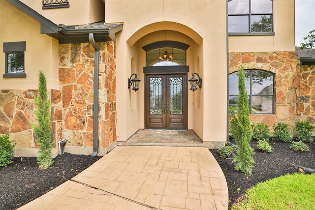 8410 Den Oak Dr, Richmond, TX 77406 - property entrance with stone siding, stucco siding, and french doors