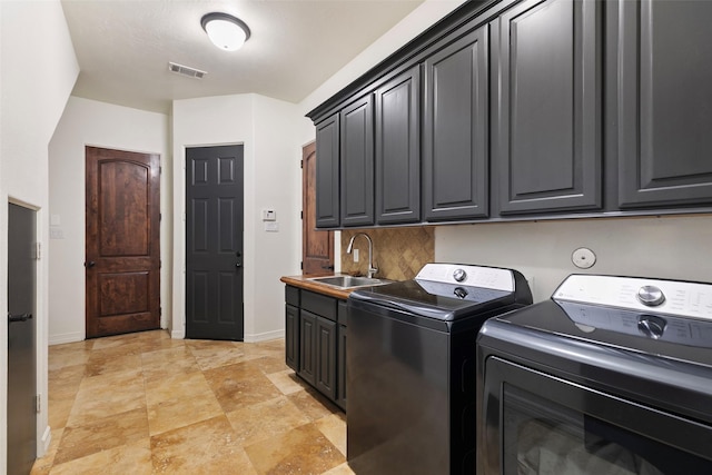 8410 Den Oak Dr, Richmond, TX 77406 - laundry room featuring washer and dryer, cabinet space, and light stone finish floors