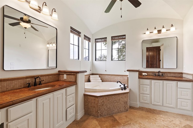 8410 Den Oak Dr, Richmond, TX 77406 - full bathroom with ceiling fan, vaulted ceiling, two vanities, a garden tub, and tasteful backsplash