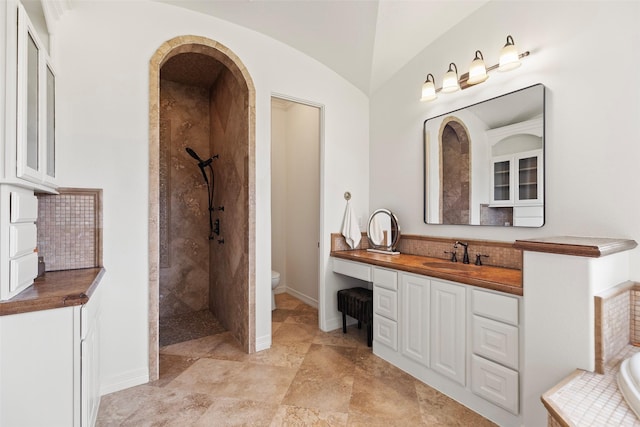 8410 Den Oak Dr, Richmond, TX 77406 - full bathroom featuring vanity, tiled shower, and lofted ceiling
